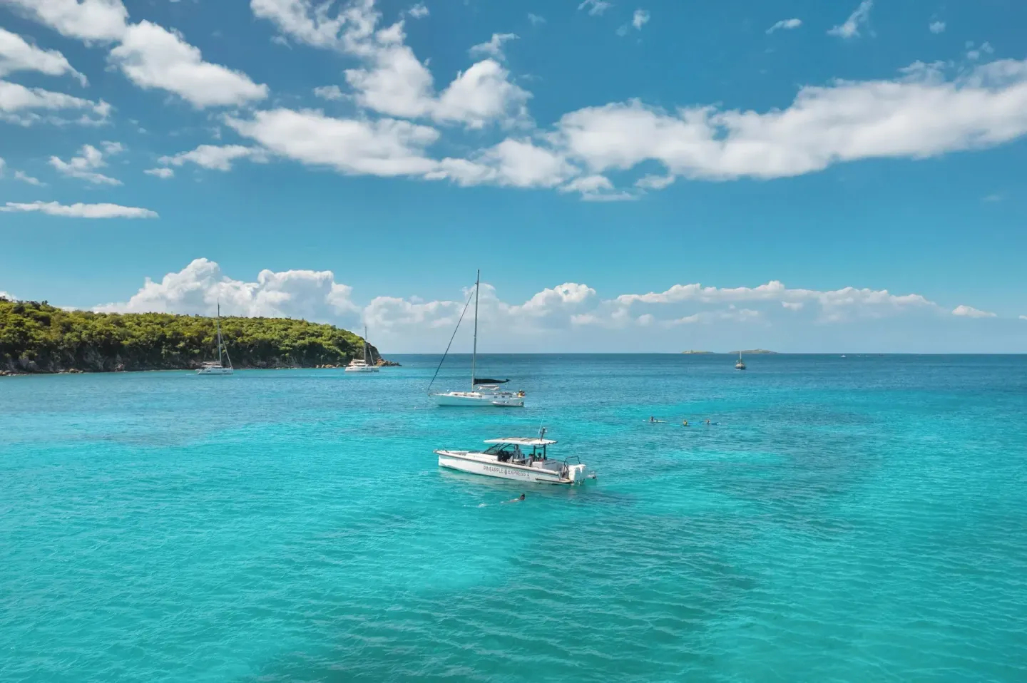 Boats float on turquoise bay water near The Westin St. Thomas Beach Resort & Spa.