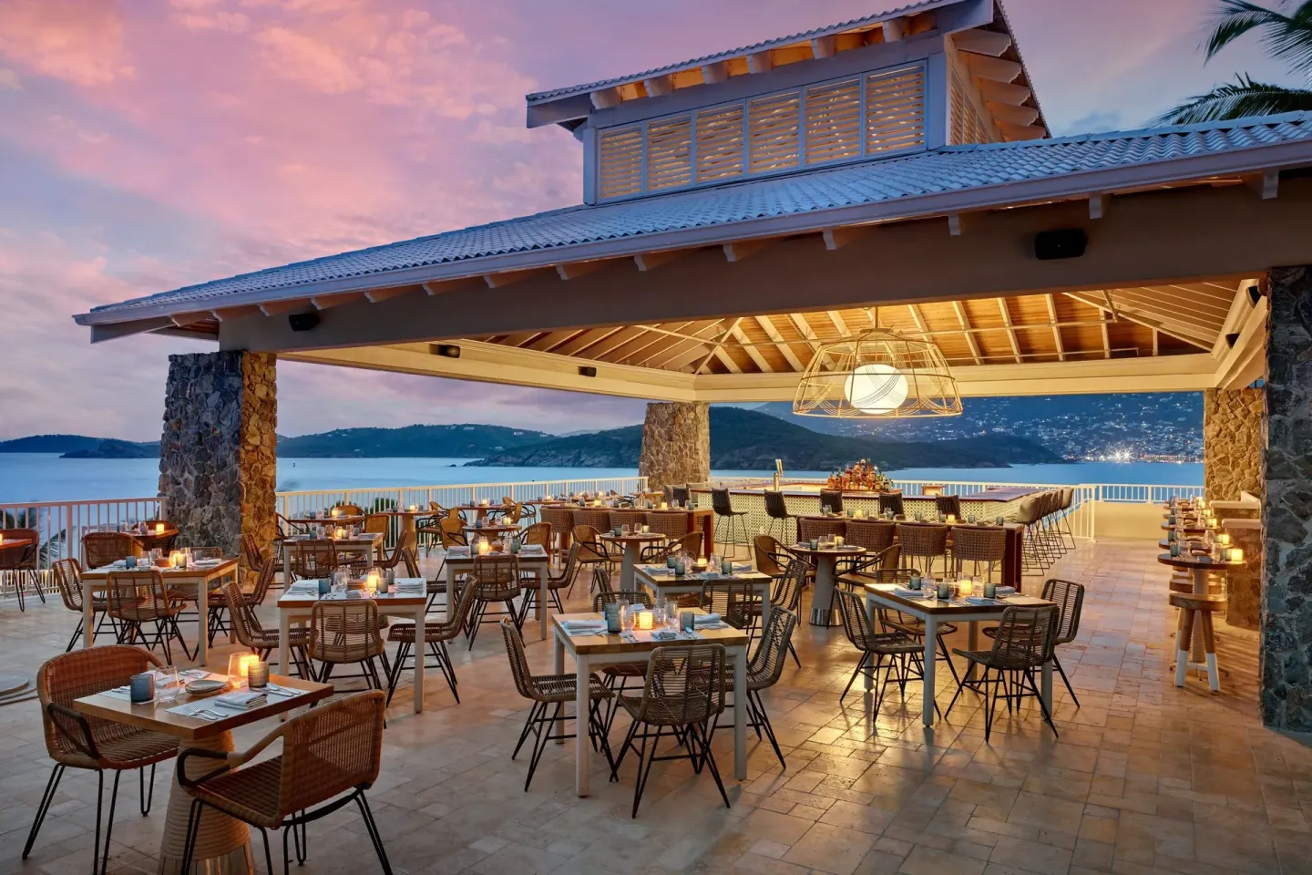 Open-air terrace restaurant at sunset at The Westin St. Thomas Beach Resort & Spa.