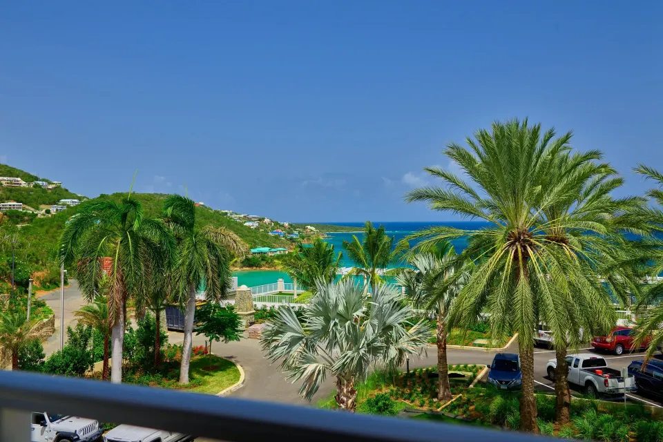 Garden View room balcony overlooks palms and hillside water views at The Westin St. Thomas Beach Resort & Spa.
