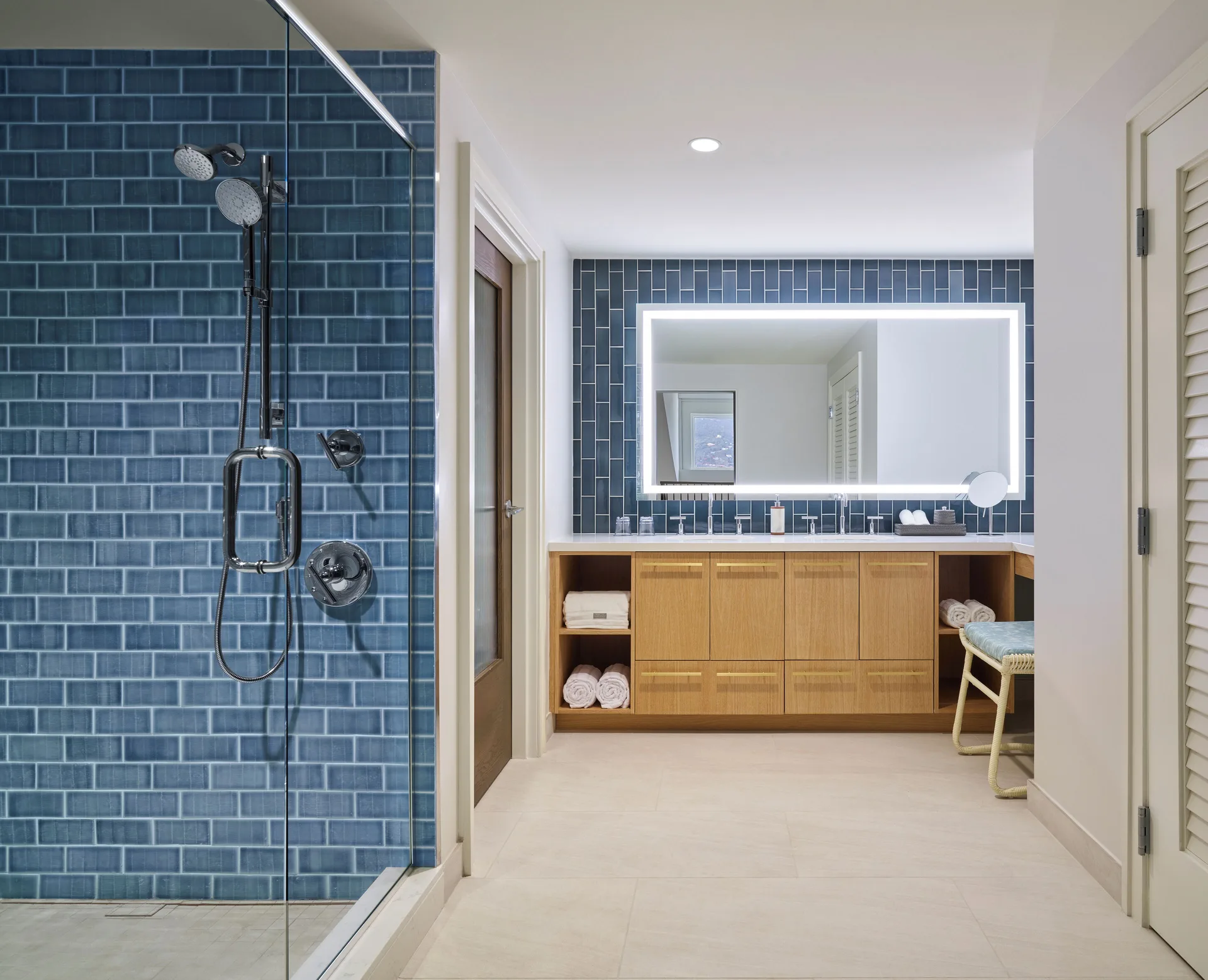 Suite bathroom with blue tile shower and double vanity at The Westin St. Thomas Beach Resort & Spa.