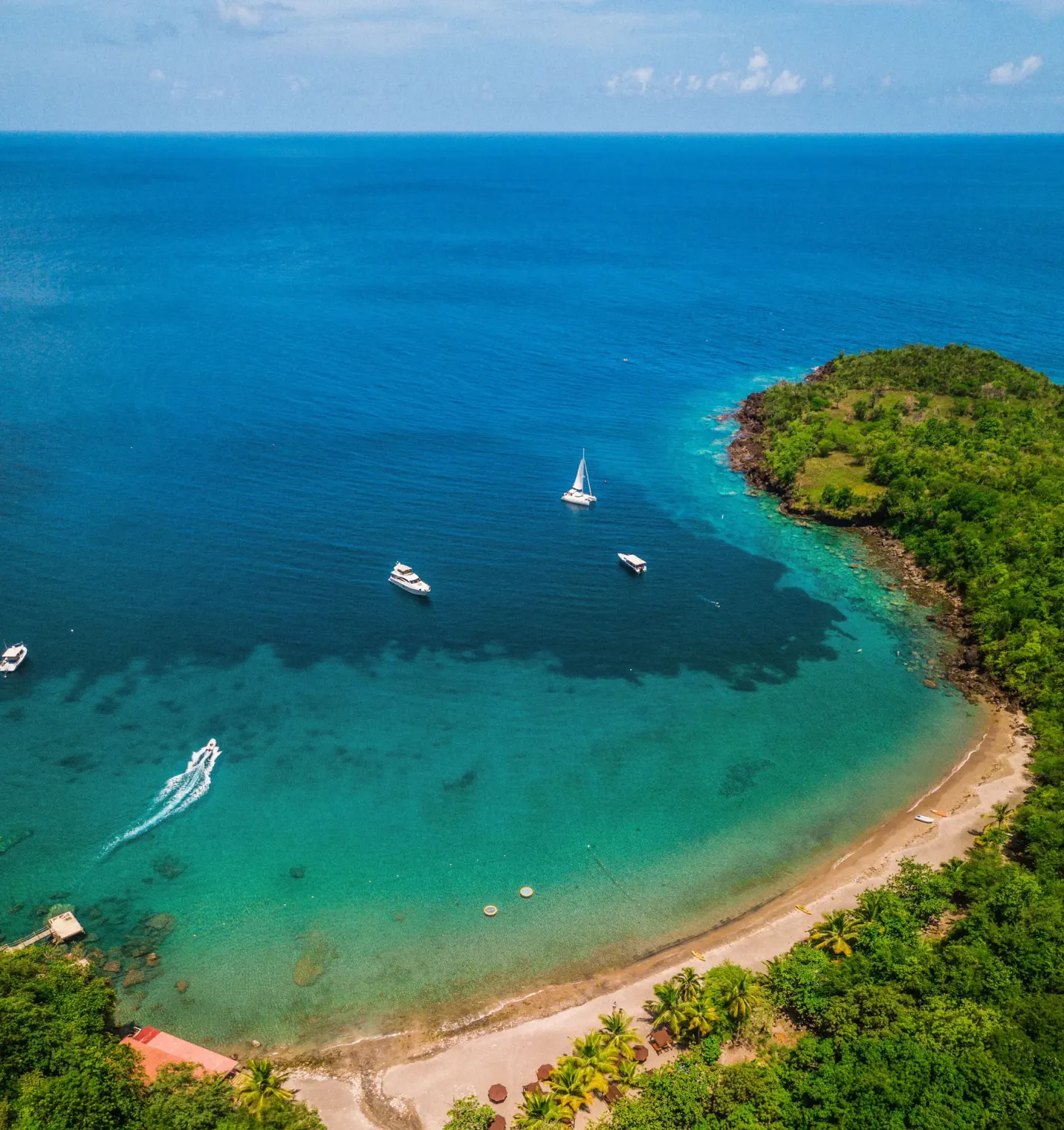 Aerial view of the cove, beach and boats at Ti Kaye Resort & Spa.