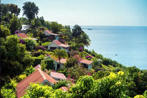 Hillside cottages and gardens overlook the sea at Ti Kaye Resort & Spa.