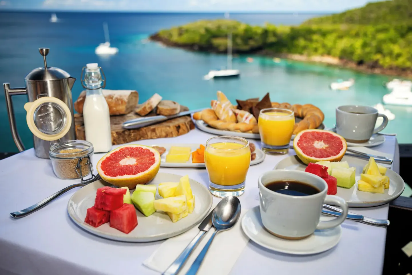 Breakfast with fruit, coffee, juice, and pastries overlooks the bay at Ti Kaye Resort & Spa.