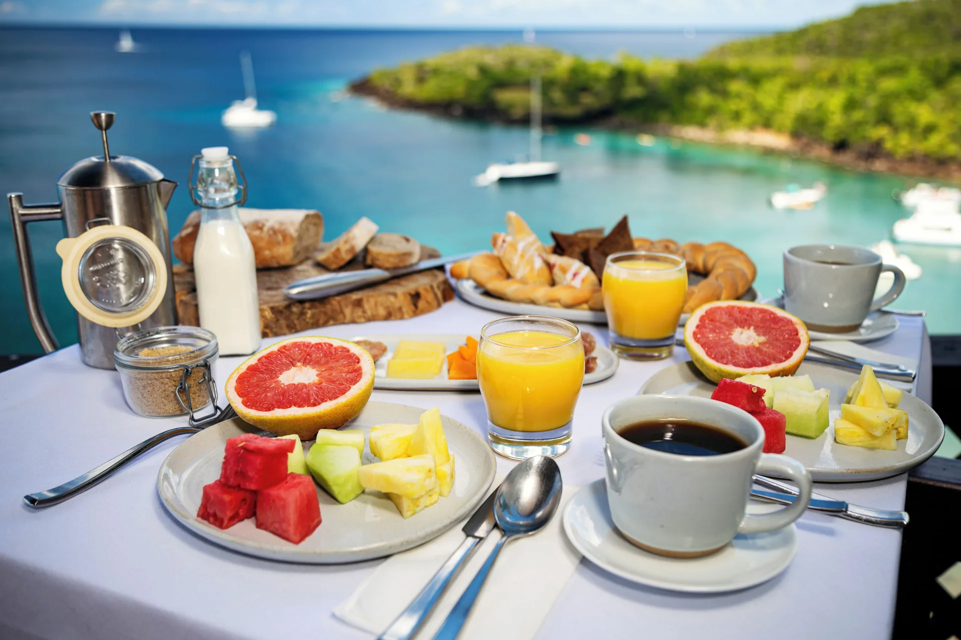 Breakfast with fruit, coffee, juice, and pastries overlooks the bay at Ti Kaye Resort & Spa.
