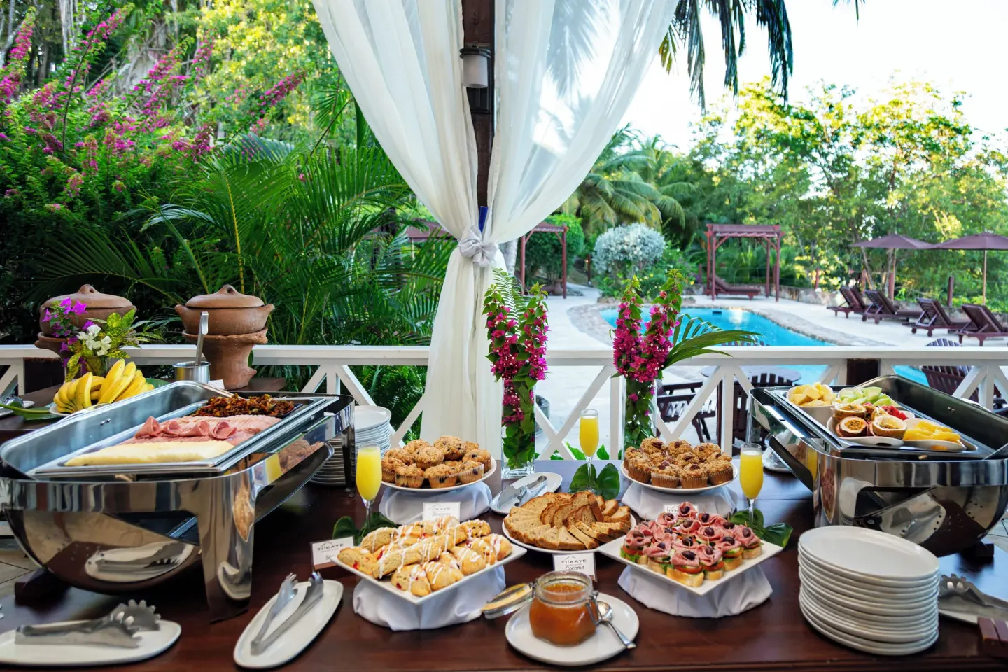 Breakfast buffet dishes are set beside the pool at Ti Kaye Resort & Spa.