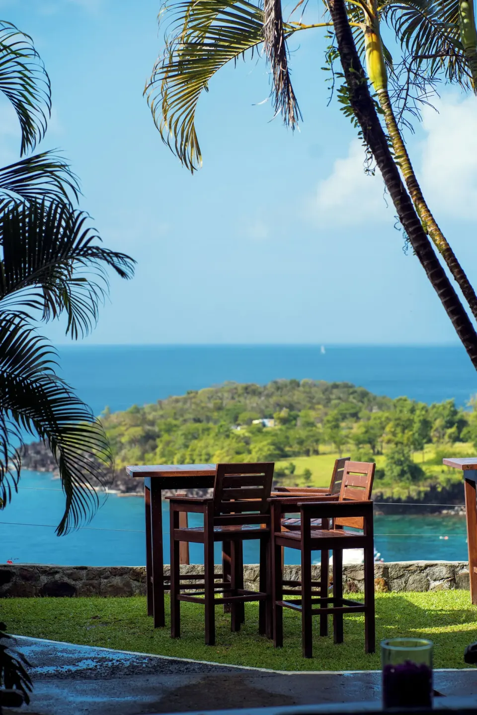 Outdoor high-top table overlooking the sea at Ti Kaye Resort & Spa.