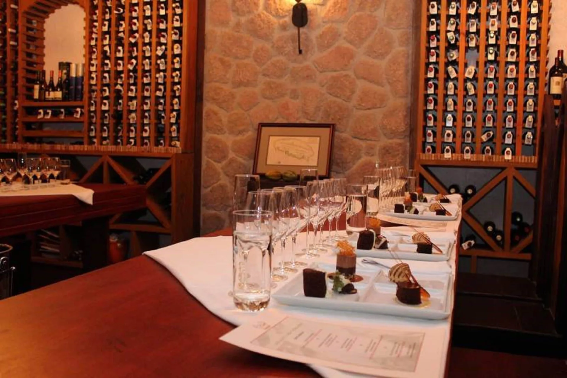 Wine glasses and plated desserts sit in the wine cellar at Ti Kaye Resort & Spa.