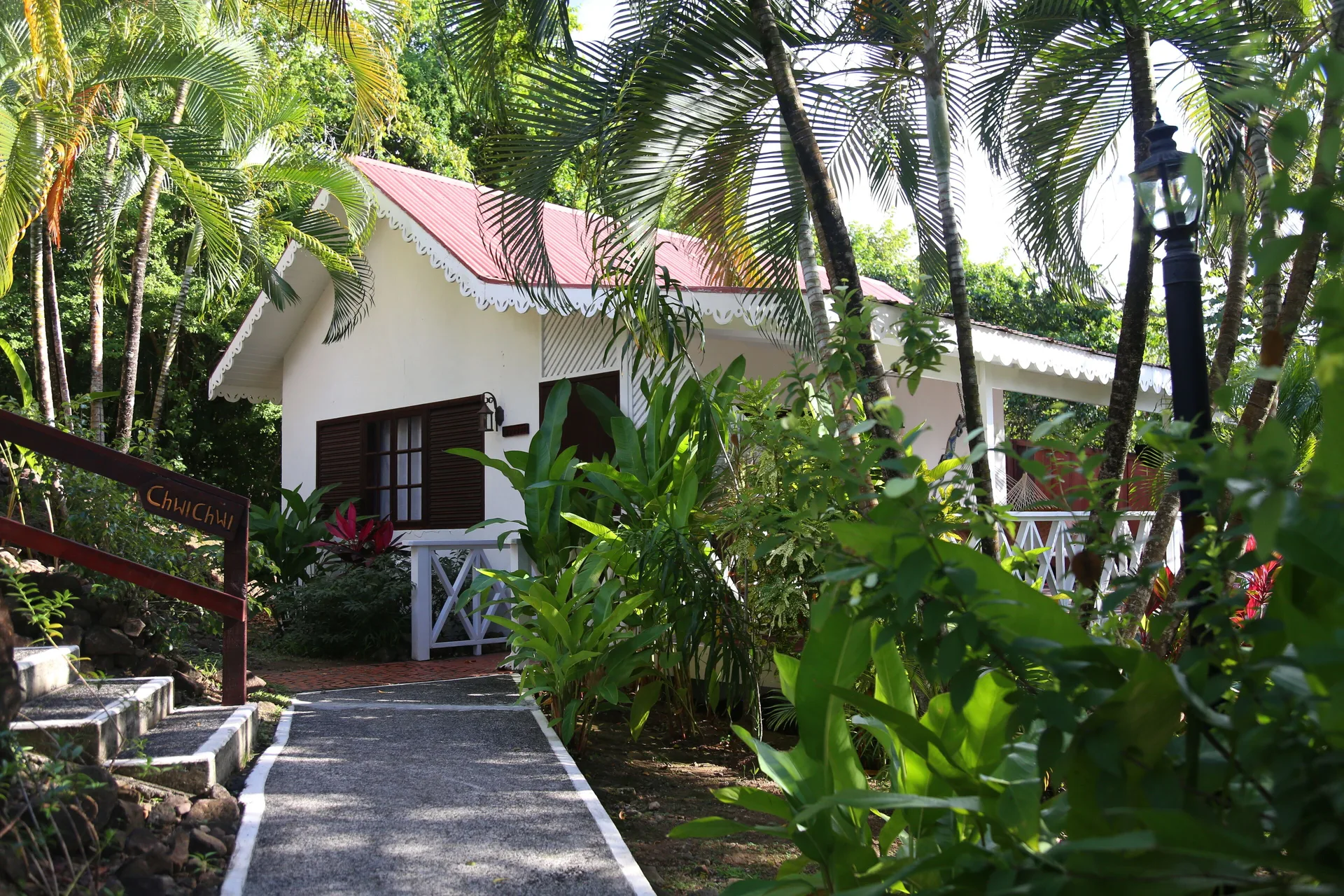 Ocean View Cottage exterior along a garden path at Ti Kaye Resort & Spa.