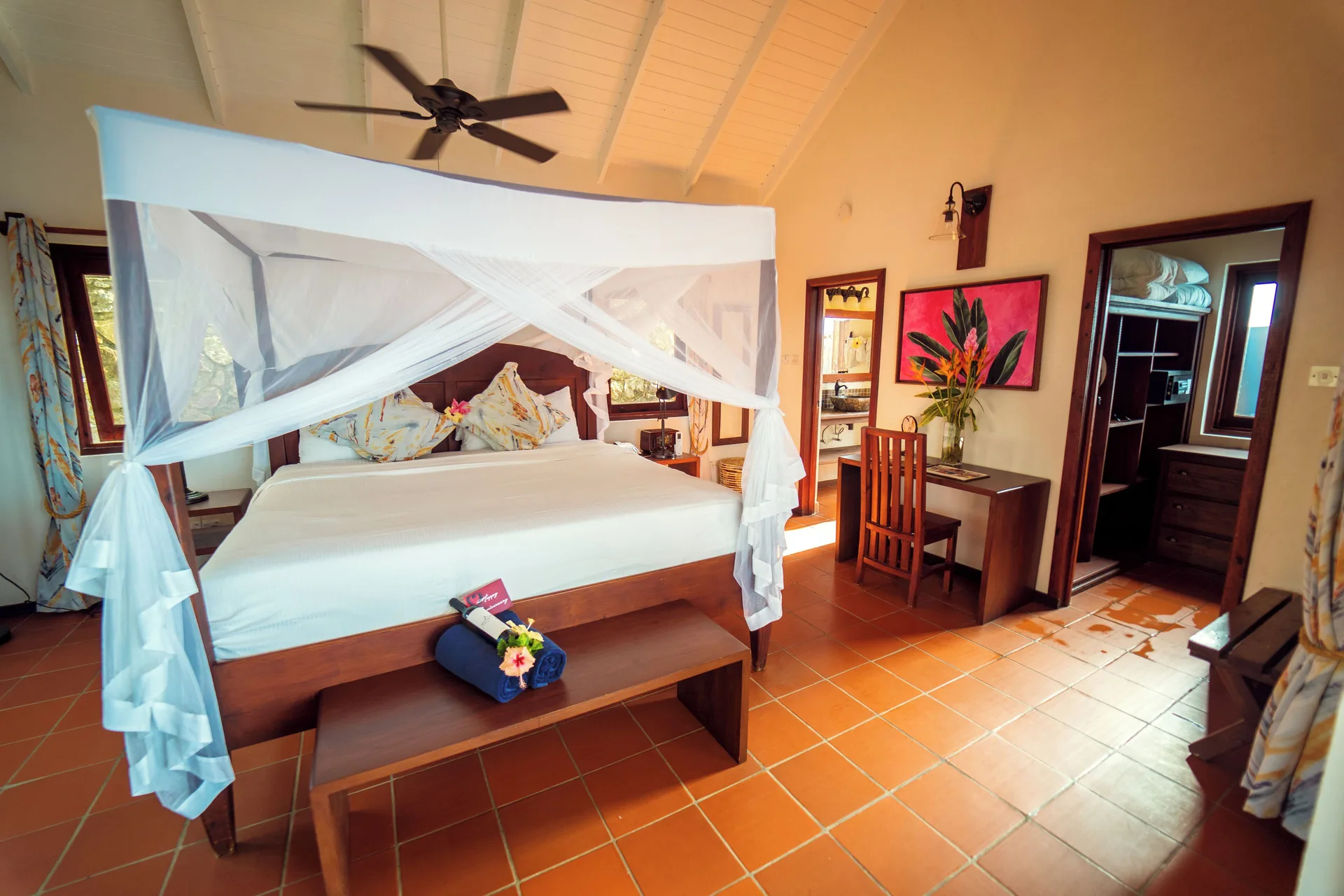 Ocean View Cottage king bed, desk, and dressing area at Ti Kaye Resort & Spa.