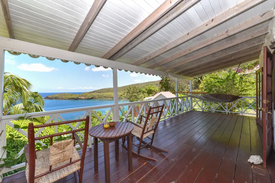 Ocean View Room balcony with rocking chairs and sea view at Ti Kaye Resort & Spa.