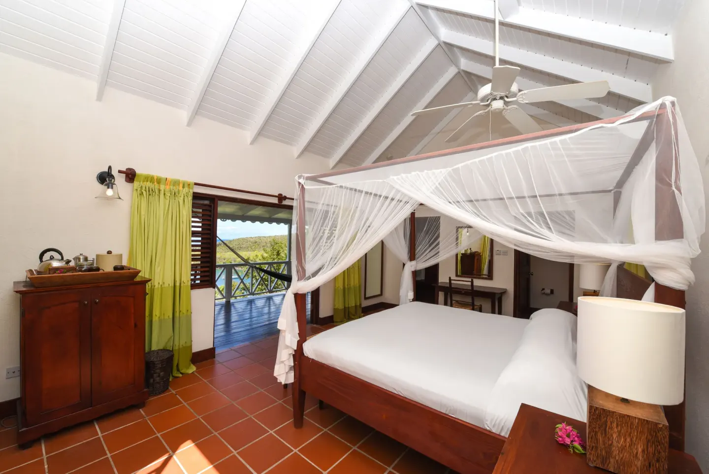 Ocean View Room bedroom with four-poster bed and balcony at Ti Kaye Resort & Spa.