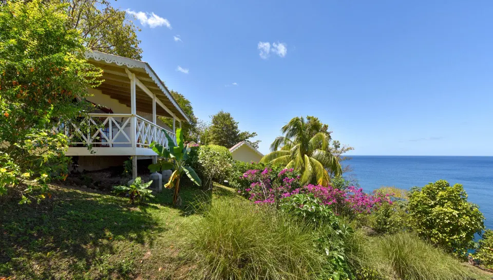 Ocean View Room exterior veranda above tropical gardens at Ti Kaye Resort & Spa.