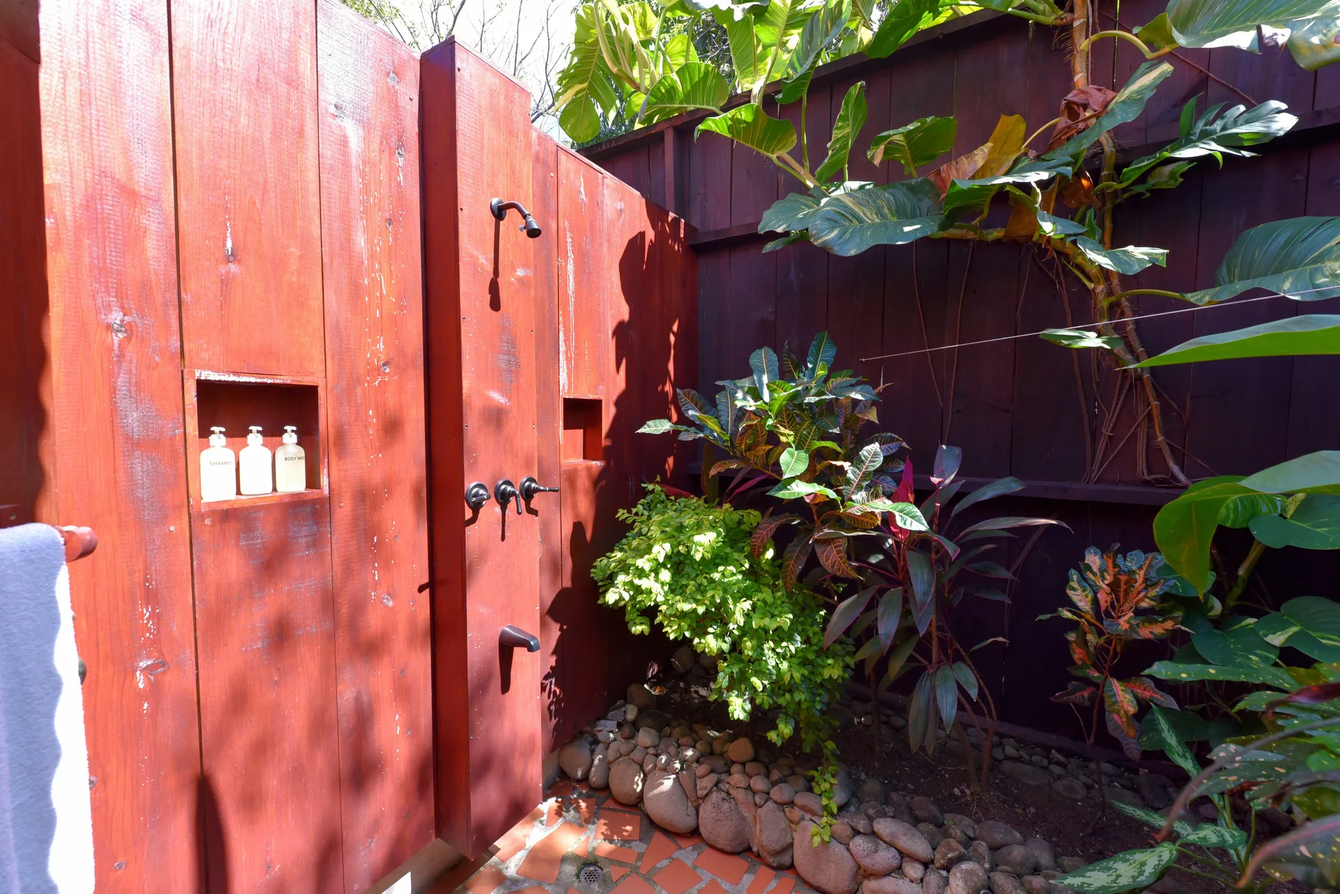 Private outdoor shower with tropical plants at Ti Kaye Resort & Spa.