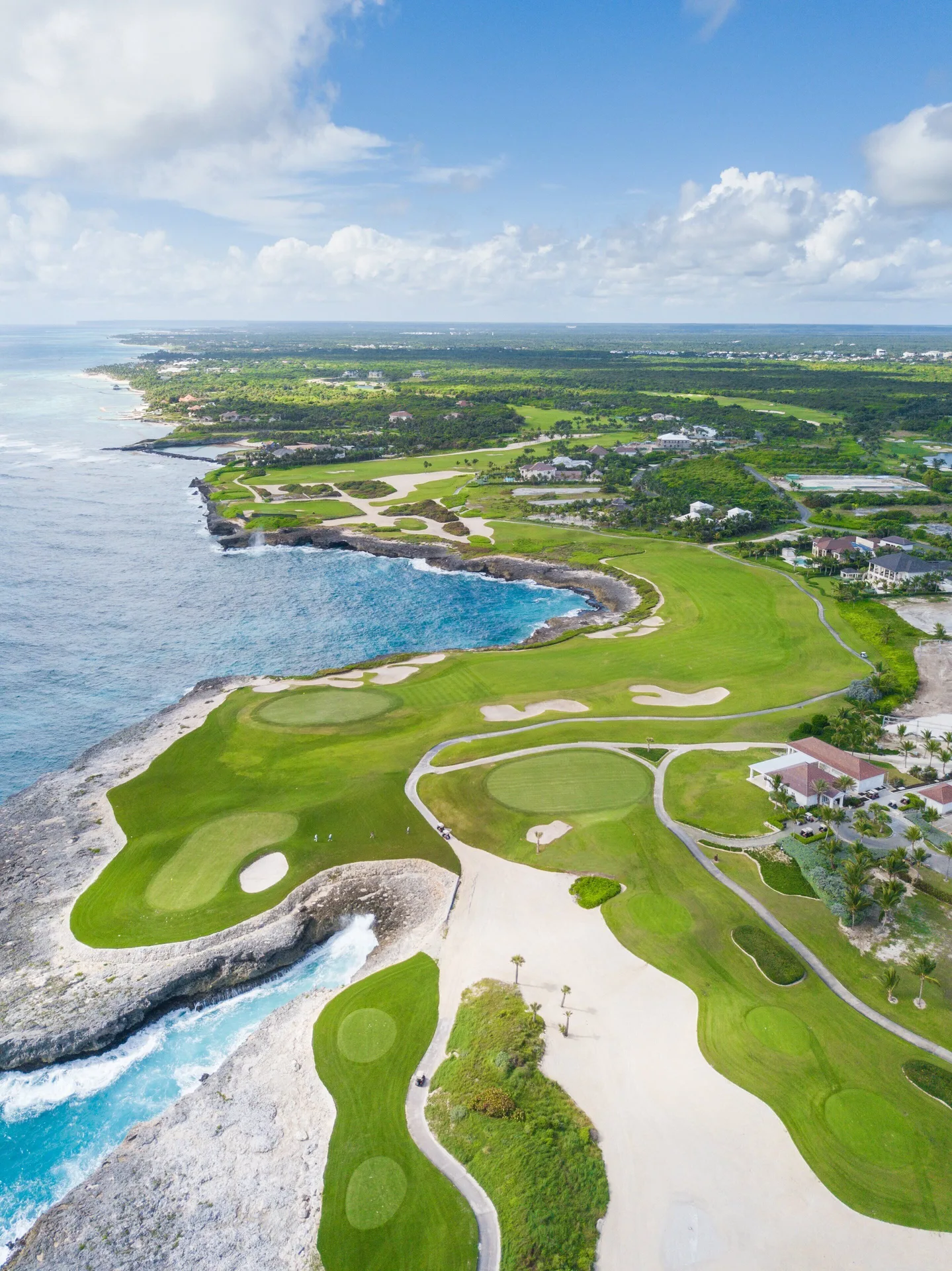 Aerial view of the oceanfront golf course and coastline at Tortuga Bay Hotel.