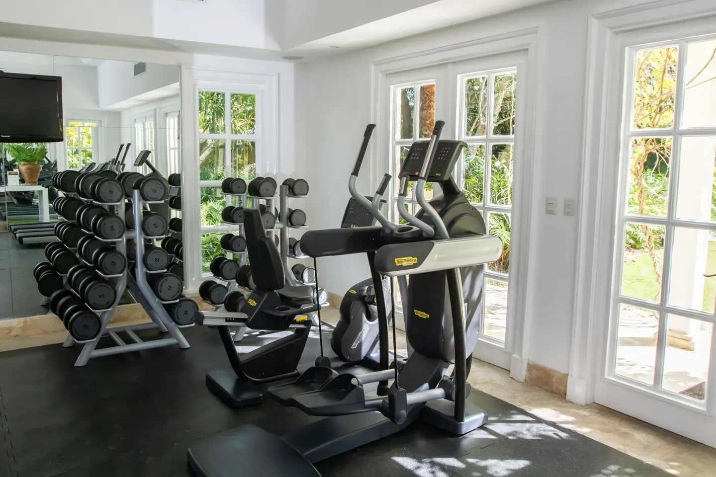 Elliptical machine and dumbbell racks by the windows at Tortuga Bay Hotel.