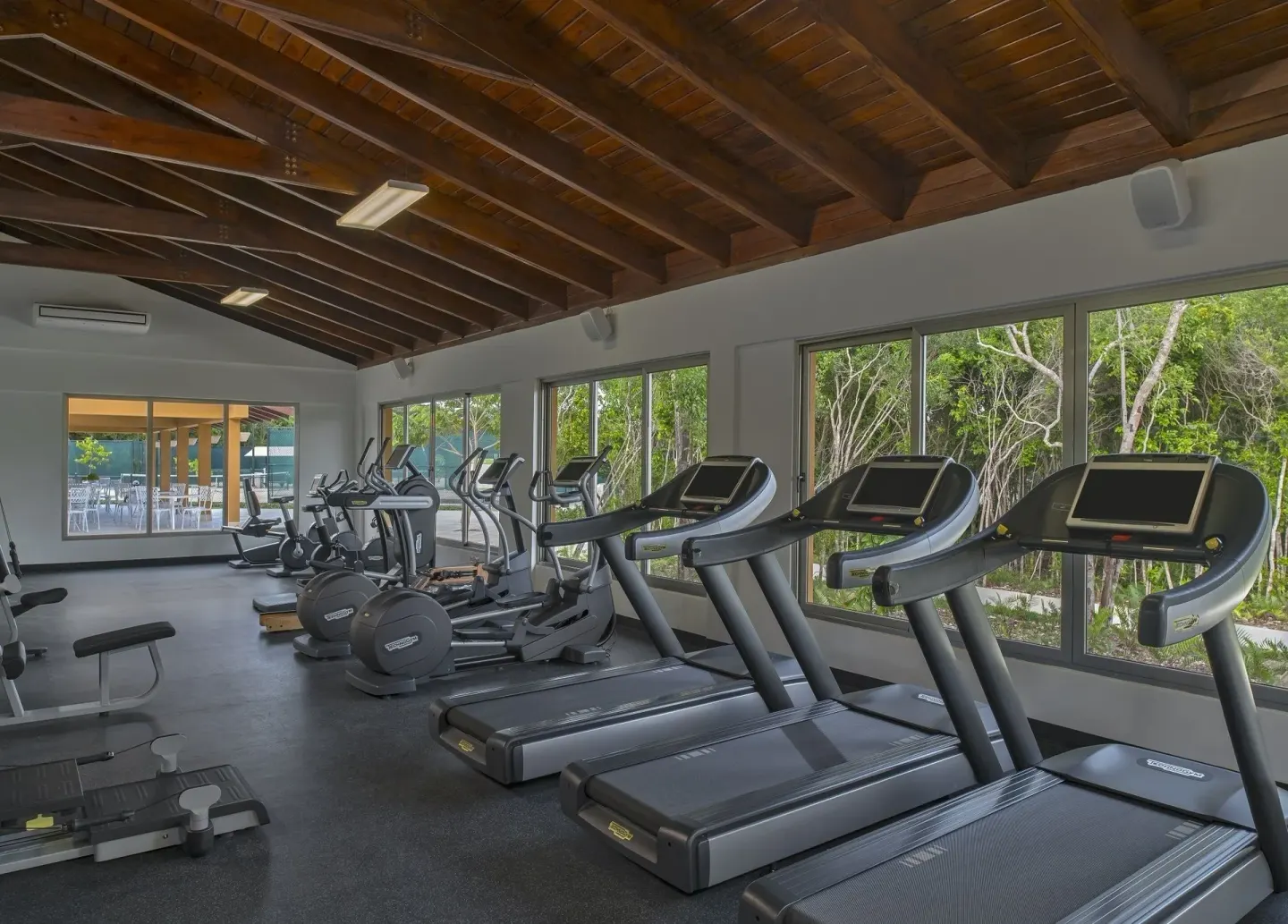 Fitness center with treadmills facing large windows at Tortuga Bay Hotel.