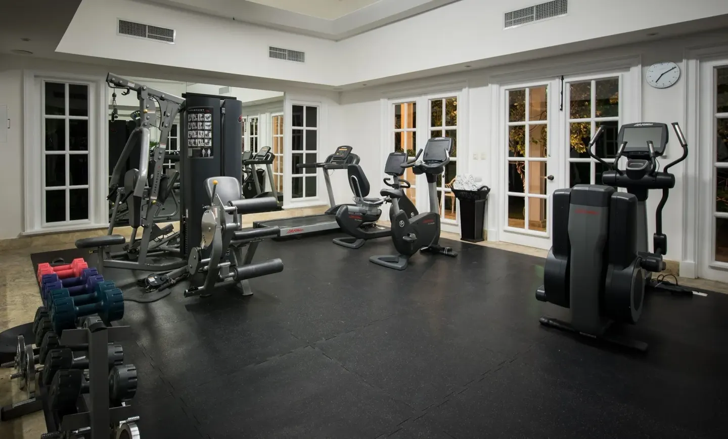 Fitness room with cardio machines and weights at Tortuga Bay Hotel.