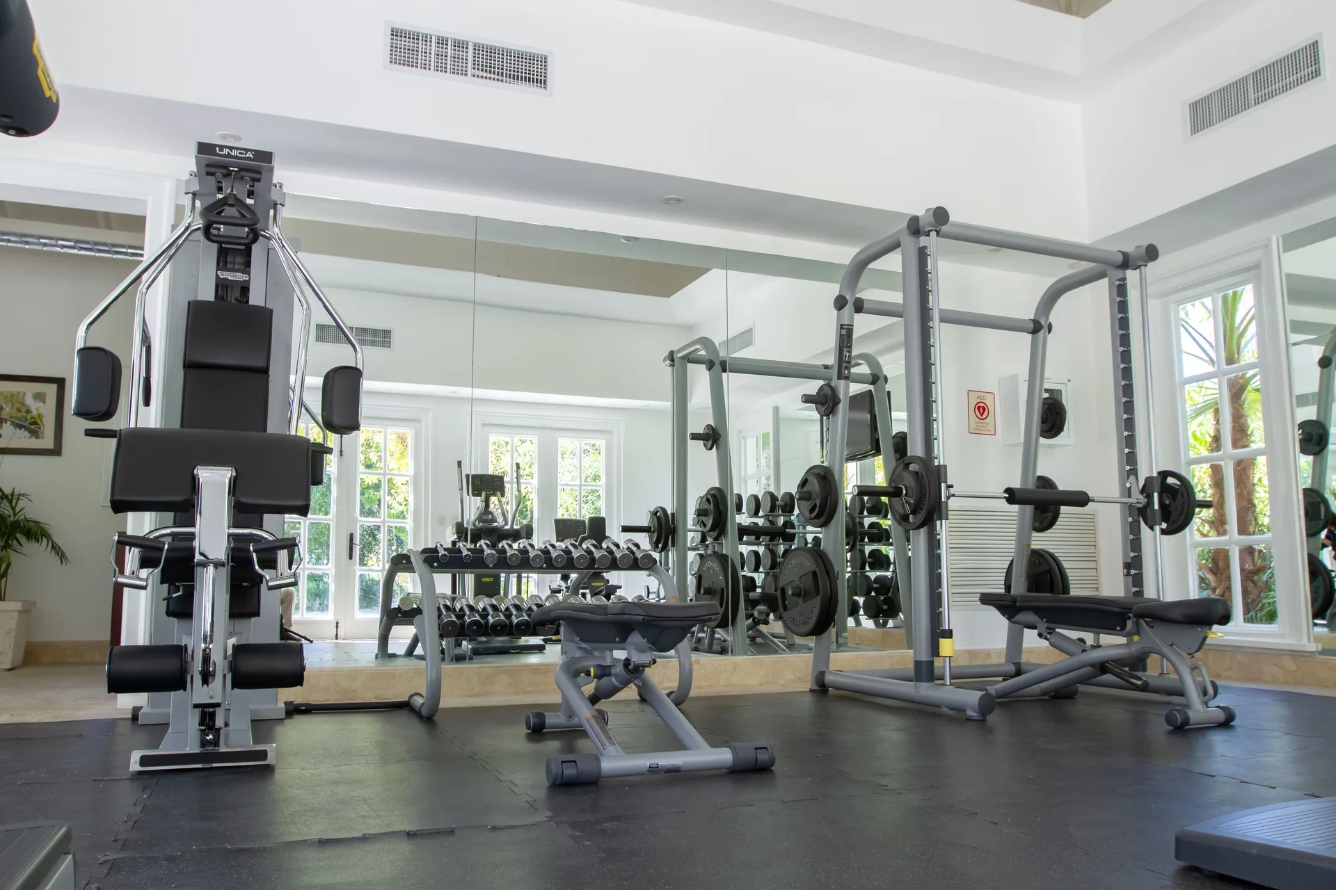 Strength machines and a weight bench in the bright gym at Tortuga Bay Hotel.