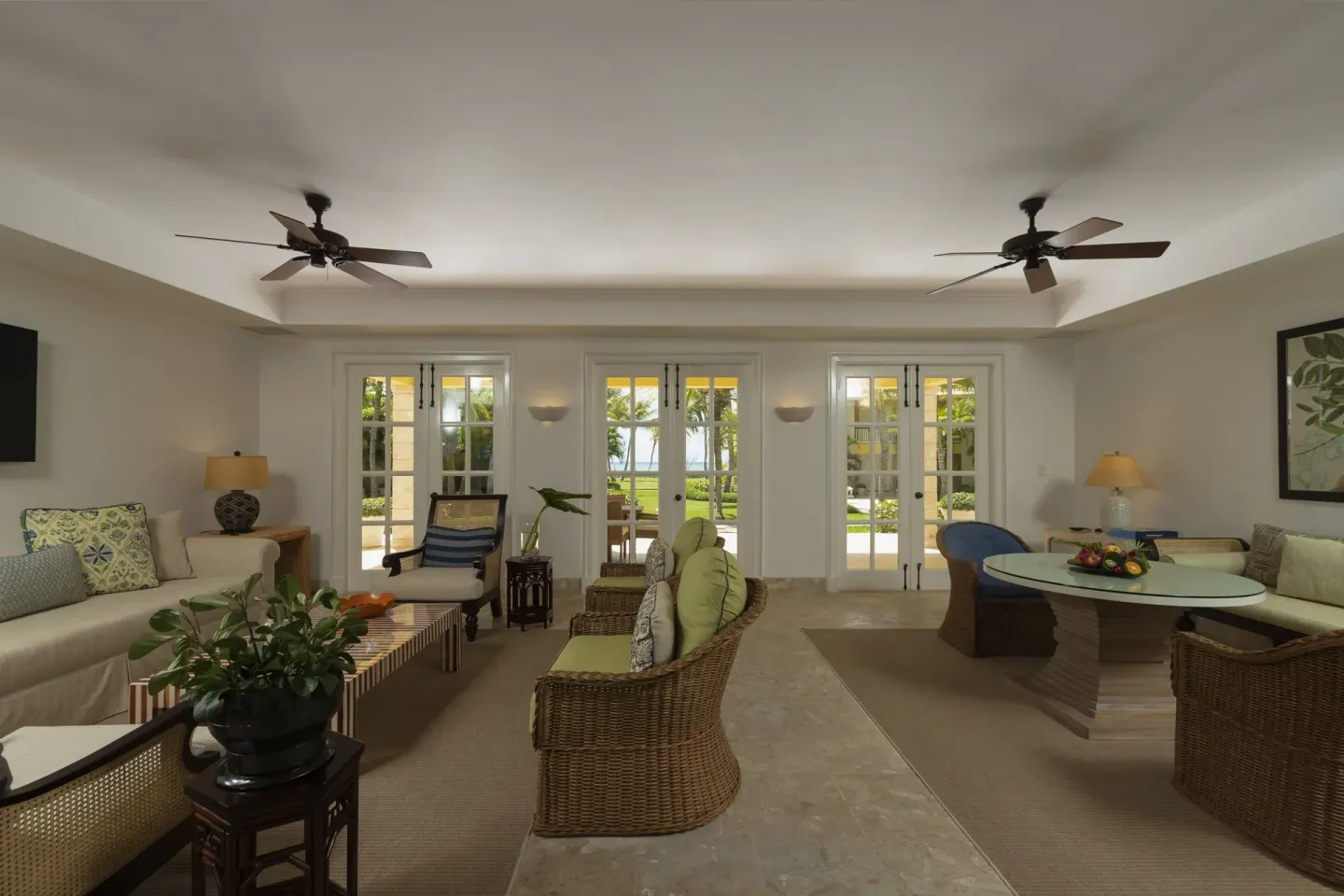Living and dining room at Tortuga Bay Hotel with French doors to the garden.