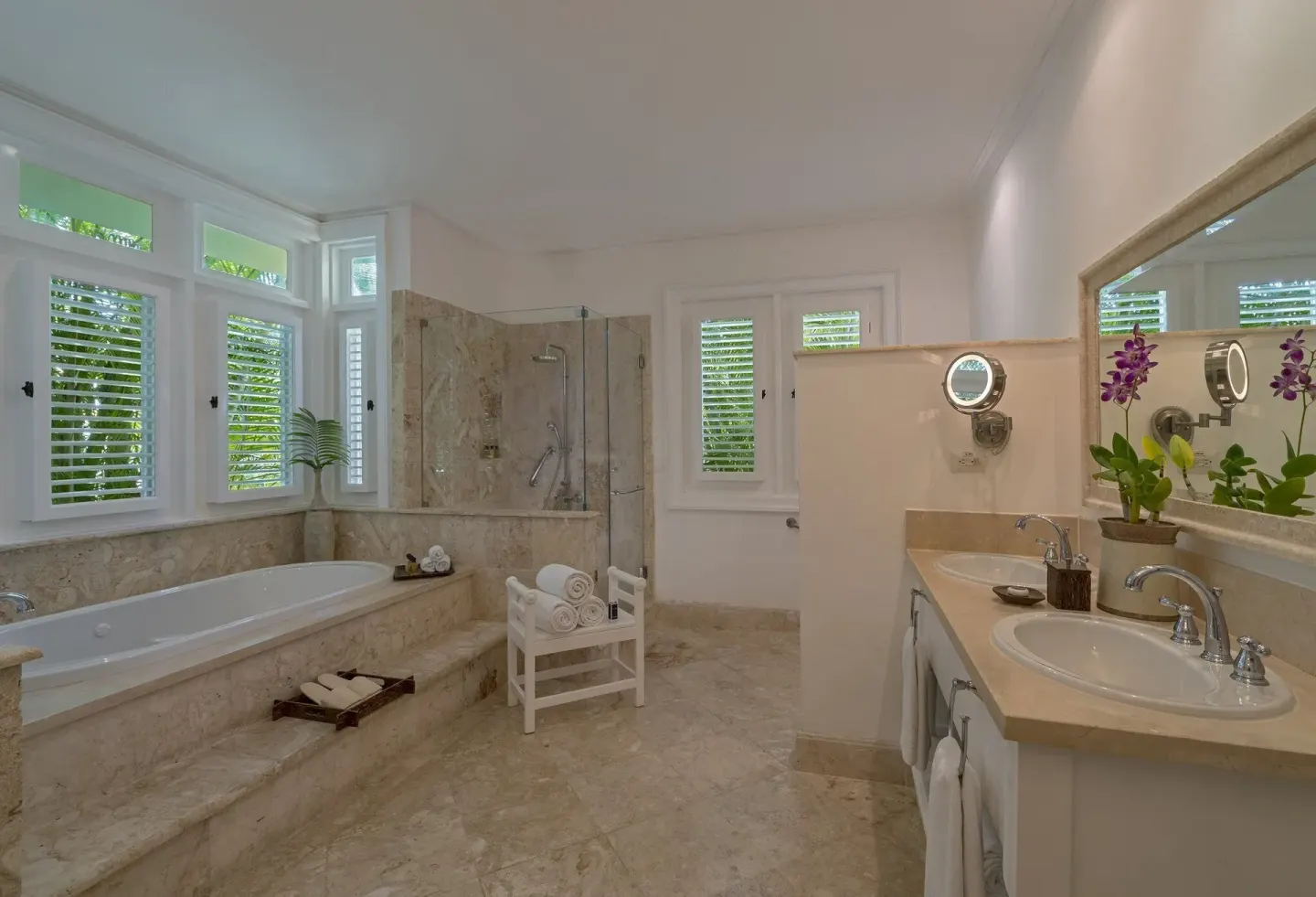 Marble bathroom with soaking tub, shower, and twin sinks at Tortuga Bay Hotel.
