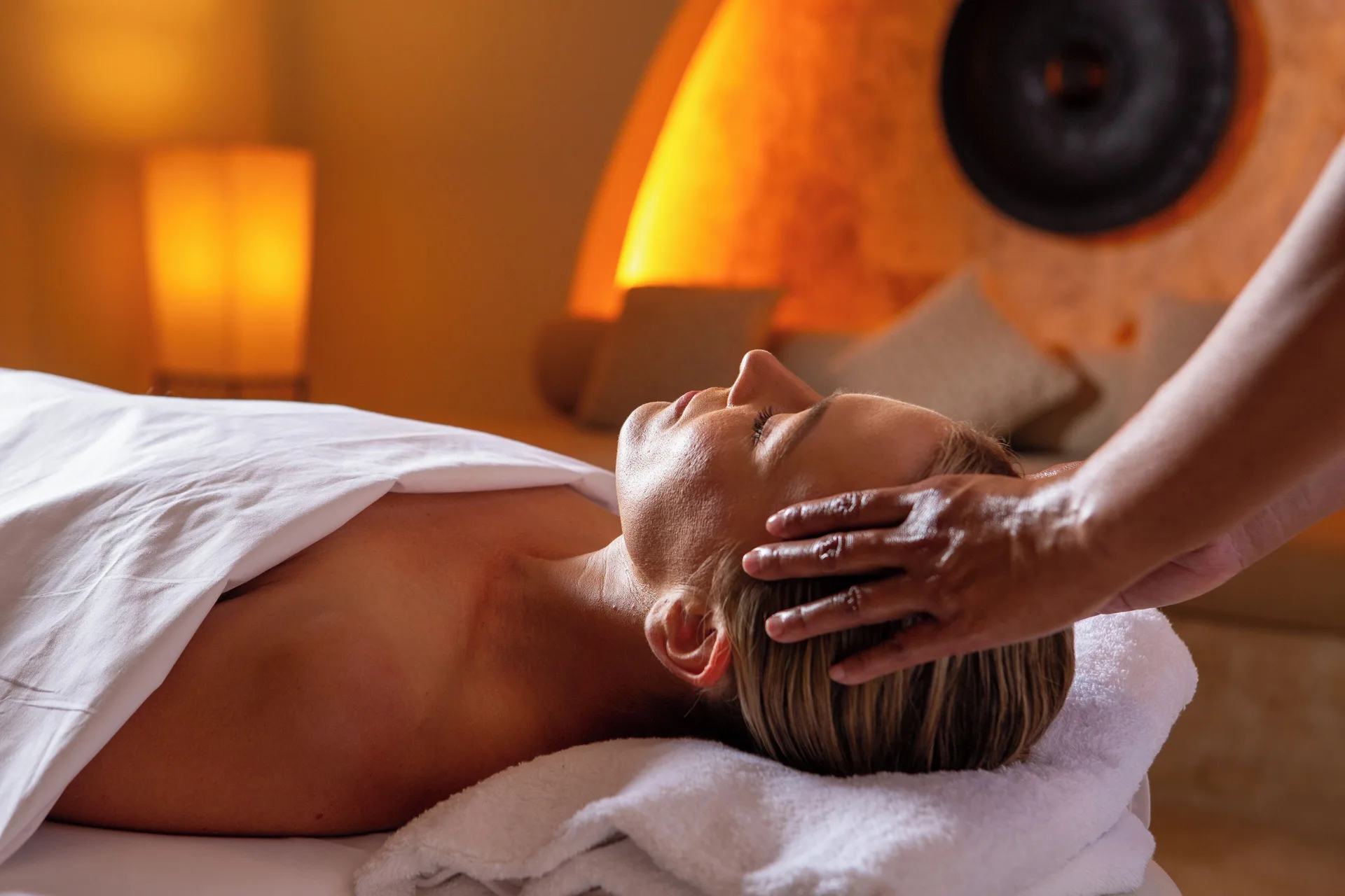 Spa guest receiving a head massage on a treatment bed at Tortuga Bay Hotel.