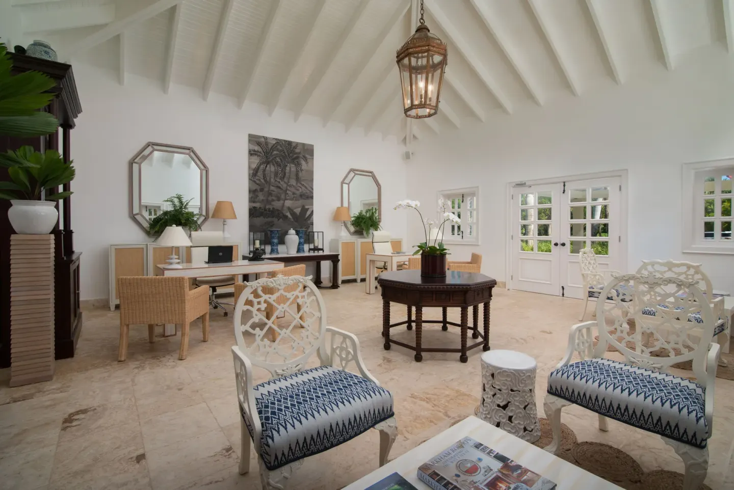 Lounge seating, desks, mirrors, and a lantern under a vaulted ceiling at Tortuga Bay Hotel.