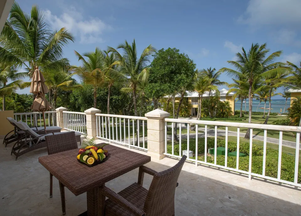 Ocean View Junior Suite balcony with table and sea view at Tortuga Bay Hotel.