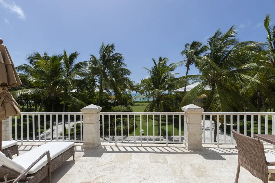 Ocean View Junior Suite terrace with palm and ocean view at Tortuga Bay Hotel.
