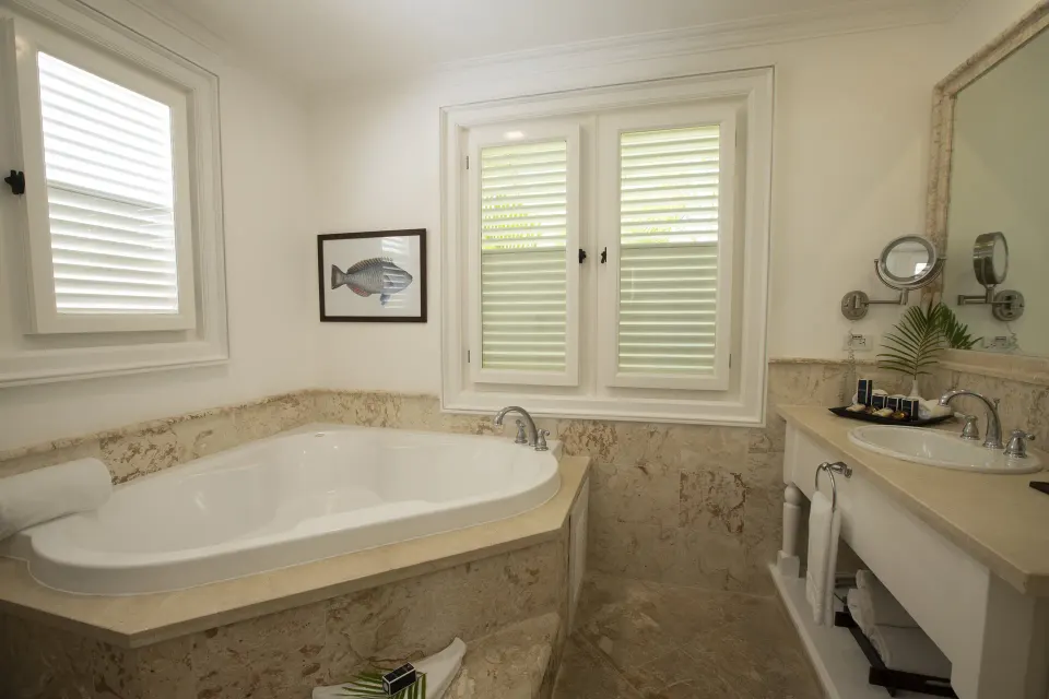 Ocean View Two Bedrooms Suite bathroom with oval tub and sink at Tortuga Bay Hotel.