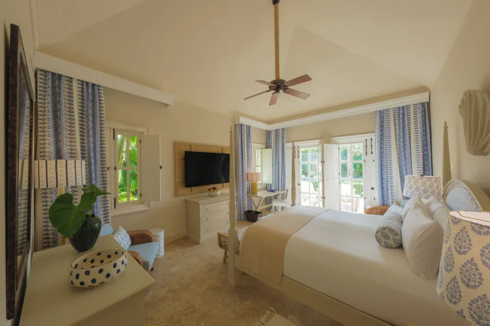 Ocean View Two Bedrooms Suite bedroom with bed and wall-mounted TV at Tortuga Bay Hotel.