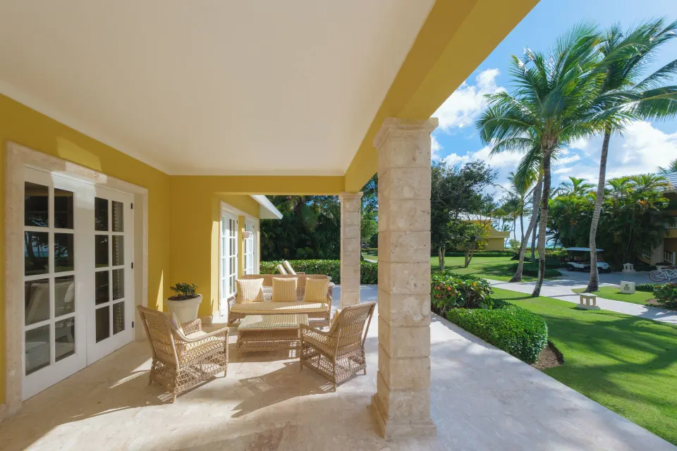Ocean View Two Bedrooms Suite covered terrace with wicker seating at Tortuga Bay Hotel.