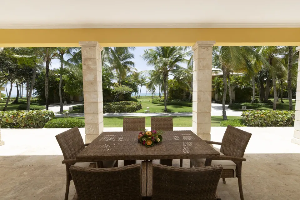 Ocean View Two Bedrooms Suite terrace dining table with palm and ocean view at Tortuga Bay Hotel.