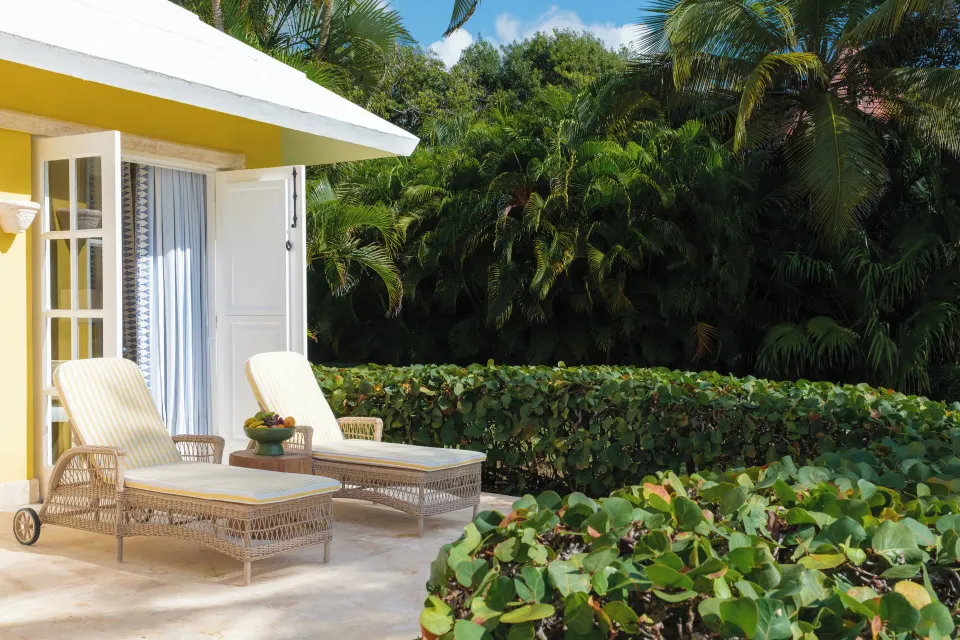 Ocean View Two Bedrooms Suite terrace loungers amid tropical greenery at Tortuga Bay Hotel.