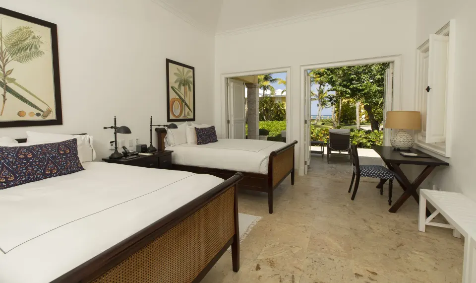 Ocean View Two Bedrooms Suite two-bed room with patio doors at Tortuga Bay Hotel.