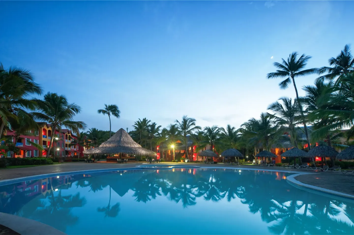 Evening pool with palm reflections at Tropical Deluxe Princess.