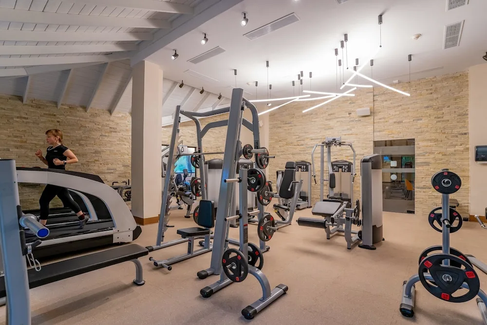 Gym with treadmill, weight racks, and exercise machines at Tropical Deluxe Princess.