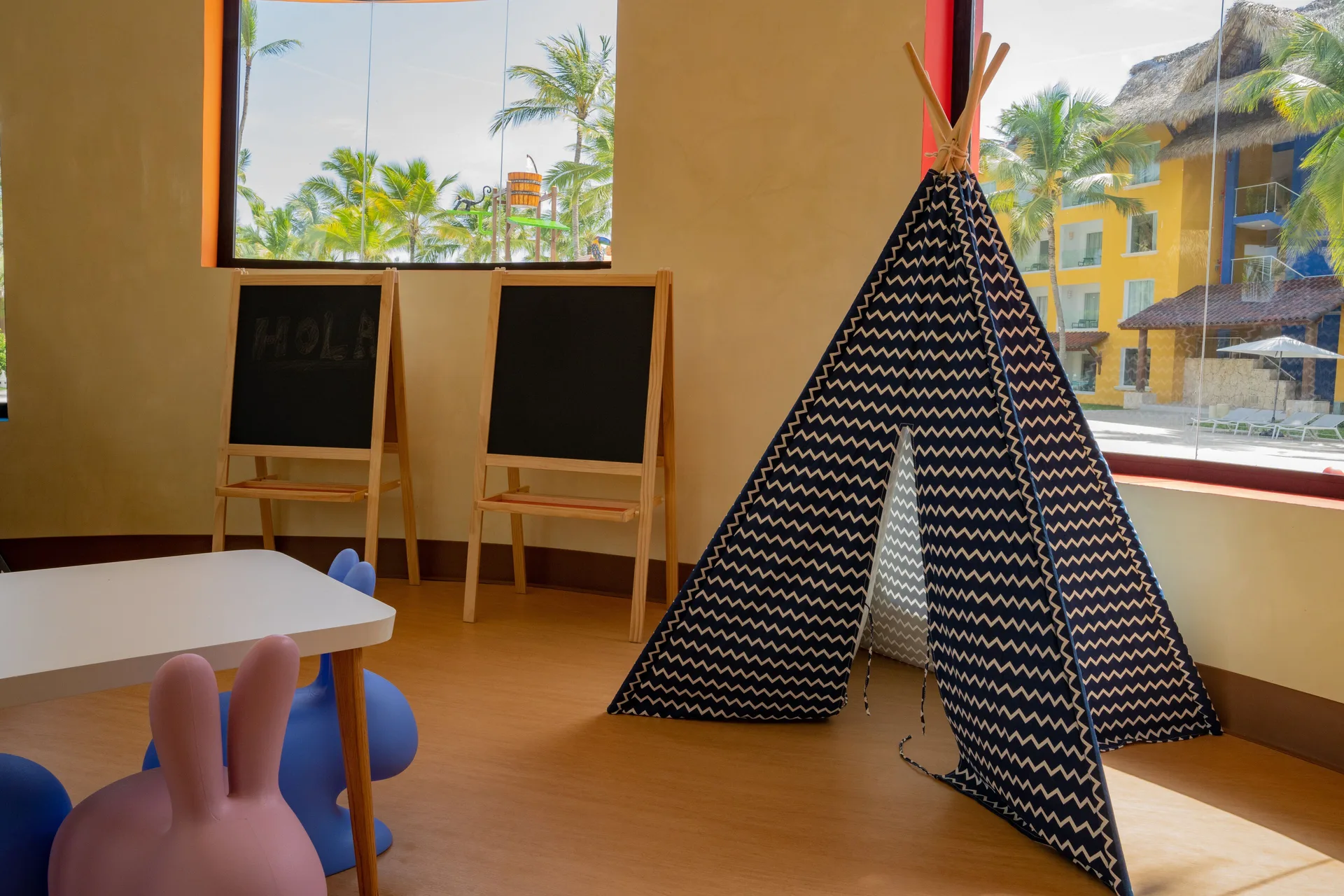 Kids club play area with a teepee and chalkboards at Tropical Deluxe Princess.