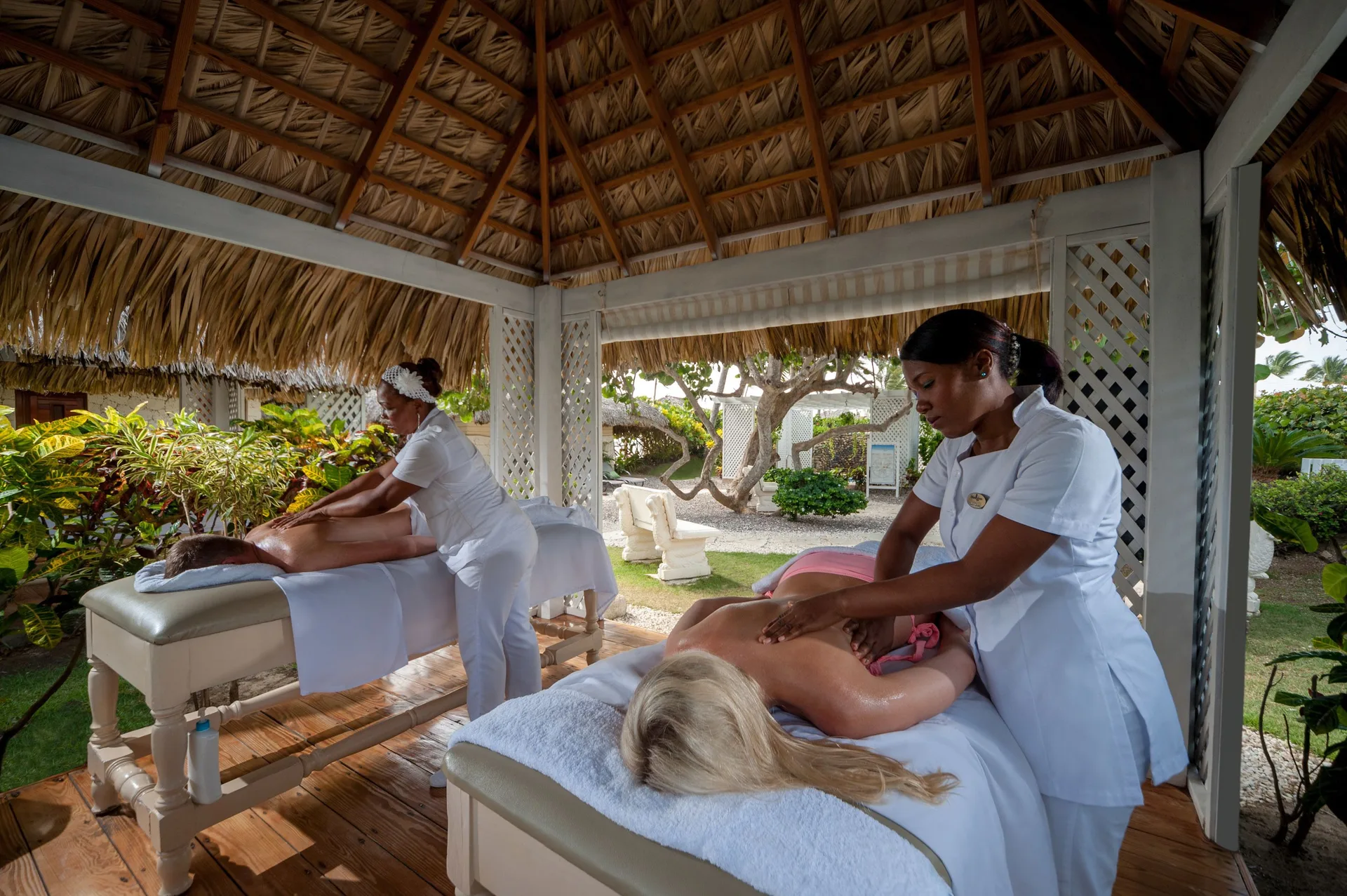 Outdoor spa massages under a thatched gazebo at Tropical Deluxe Princess.