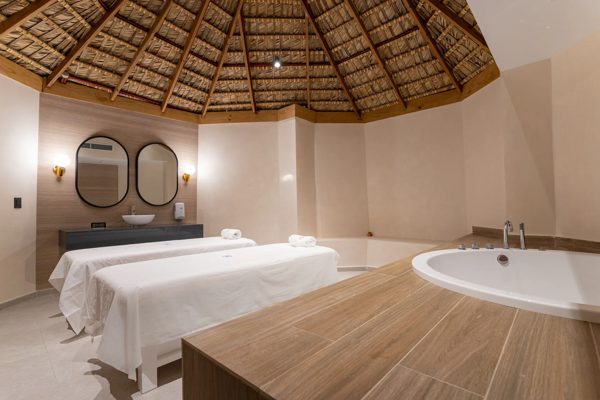 Spa treatment room with two massage beds and a soaking tub at Tropical Deluxe Princess.