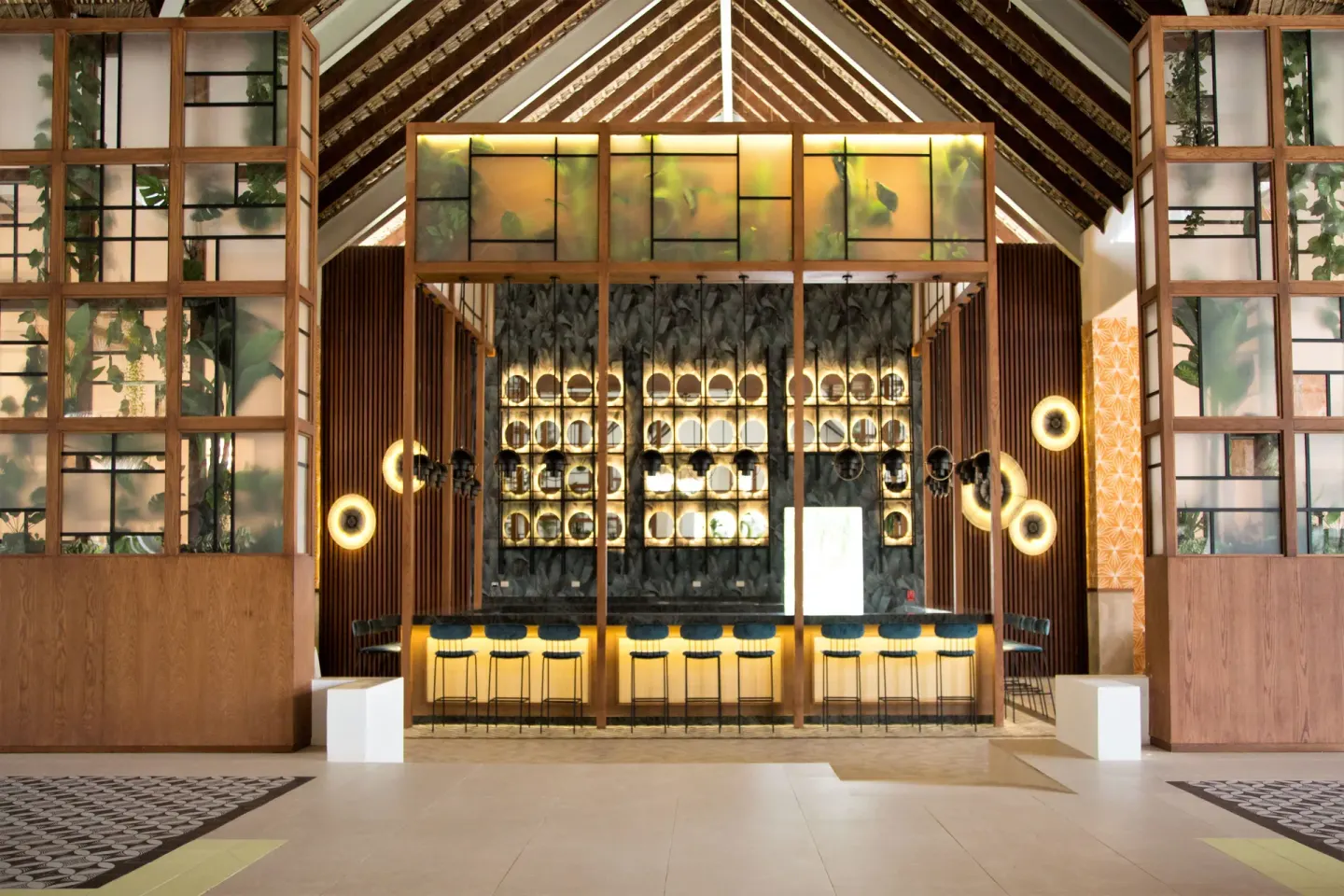 Open bar with high stools and illuminated shelves at Tropical Deluxe Princess.