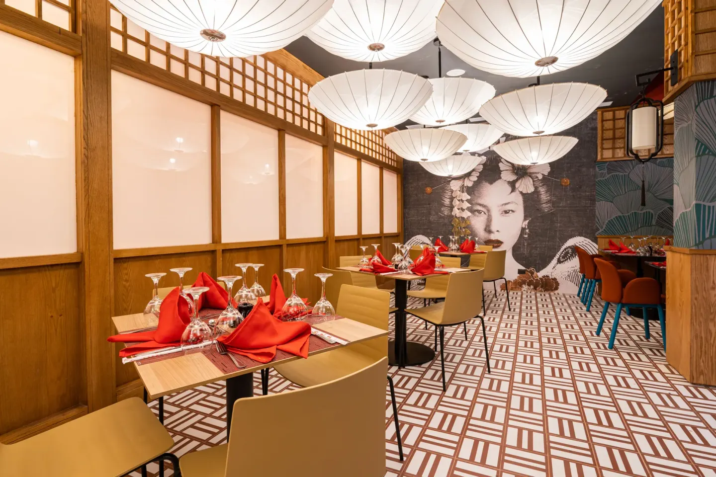 Asian-style dining room with lantern lights and red napkins at Tropical Deluxe Princess.