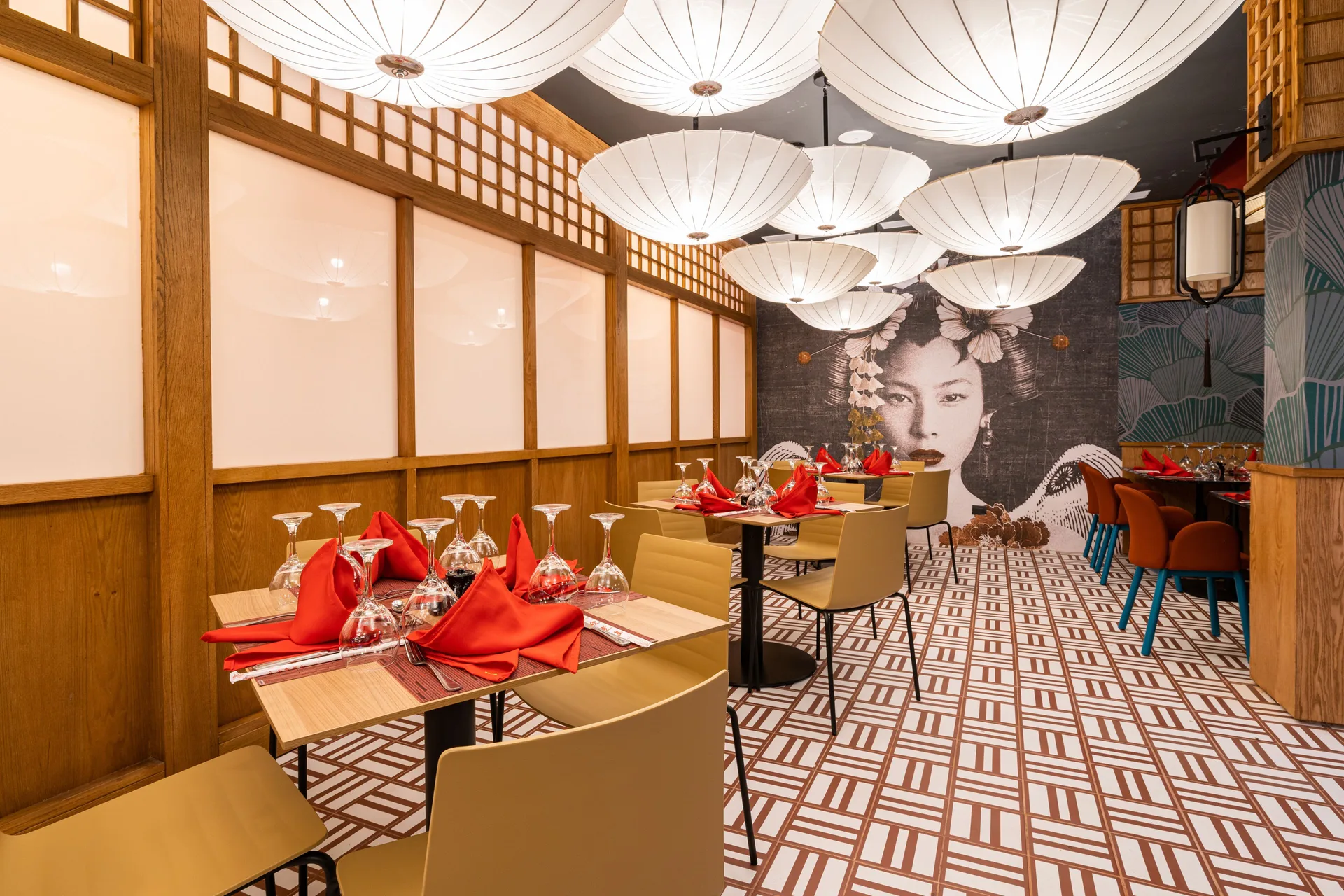 Asian-style dining room with lantern lights and red napkins at Tropical Deluxe Princess.