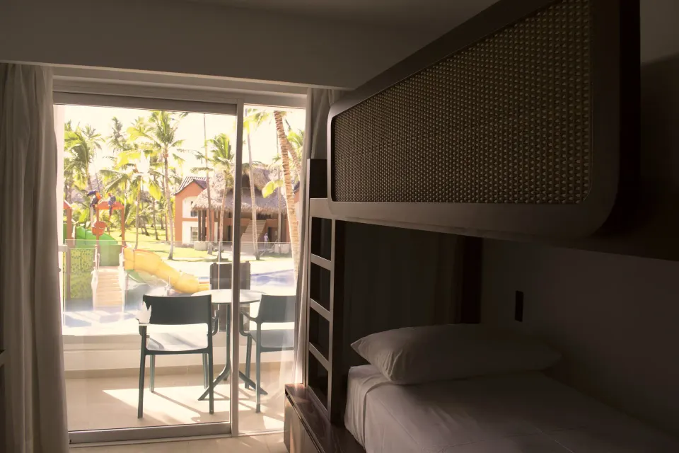 Family Room bunk bed beside balcony doors at Tropical Deluxe Princess.