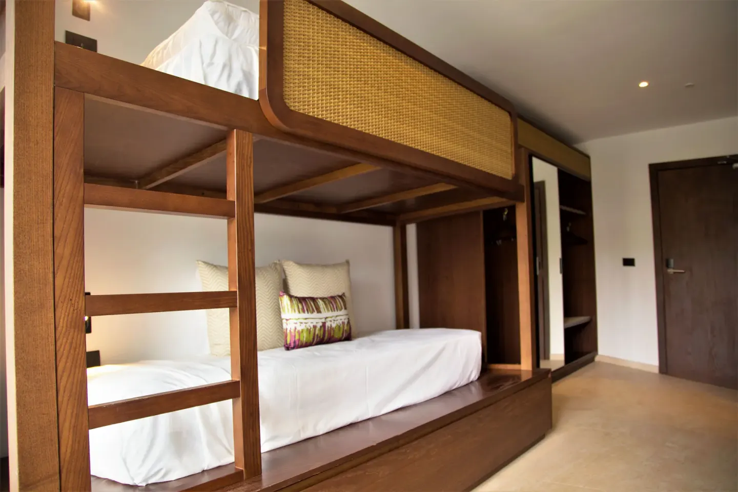 Family Room bunk beds with wood frame and ladder at Tropical Deluxe Princess.
