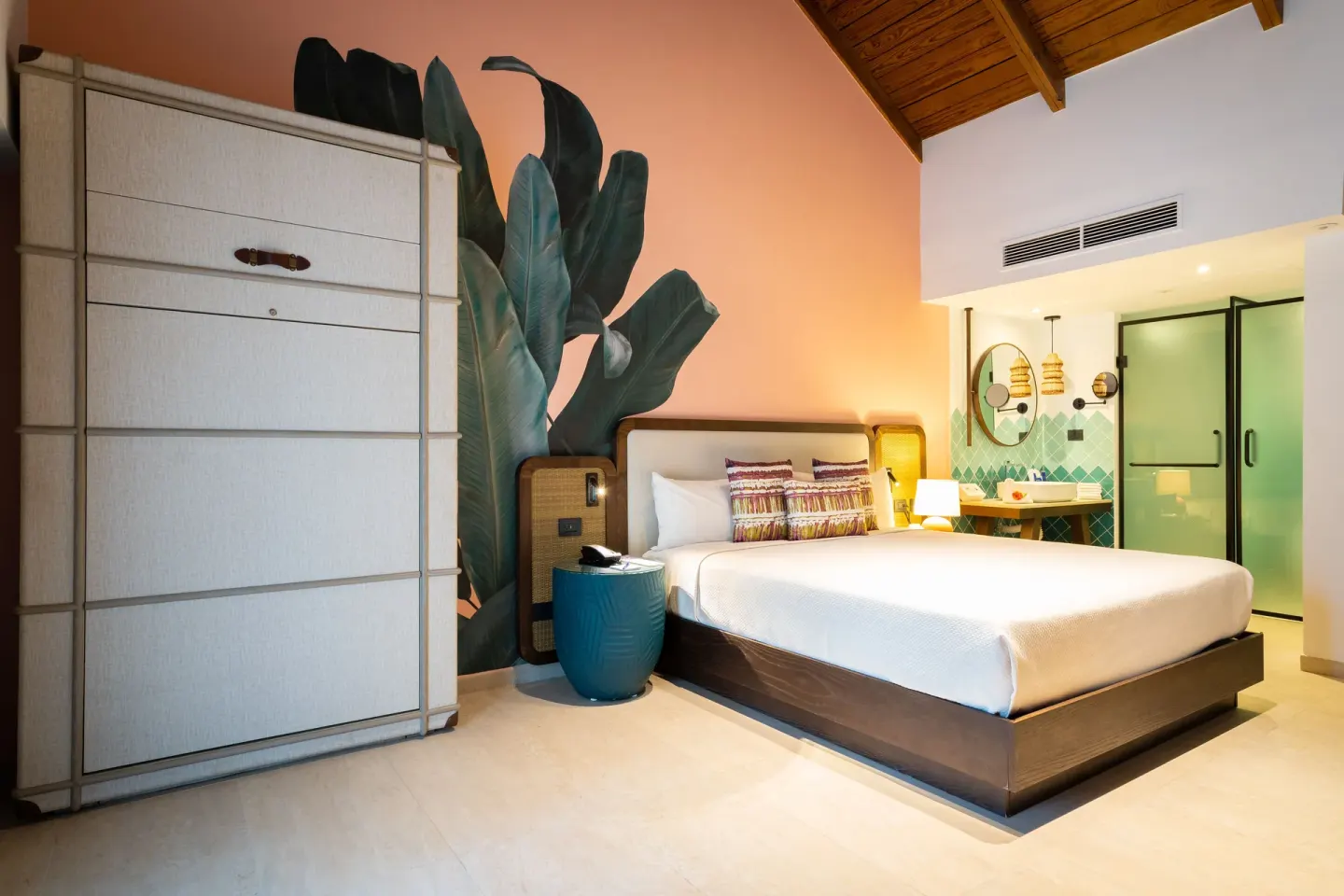 Superior Room king bed with wardrobe and green glass shower at Tropical Deluxe Princess.