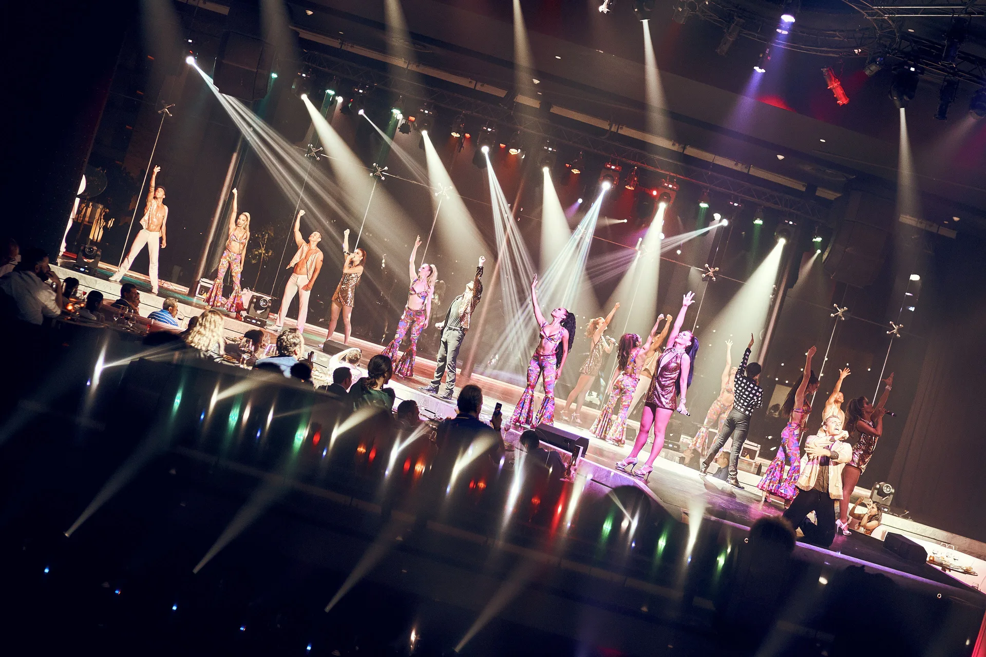 Stage performers under bright spotlights during a live show at TRS Coral Hotel.