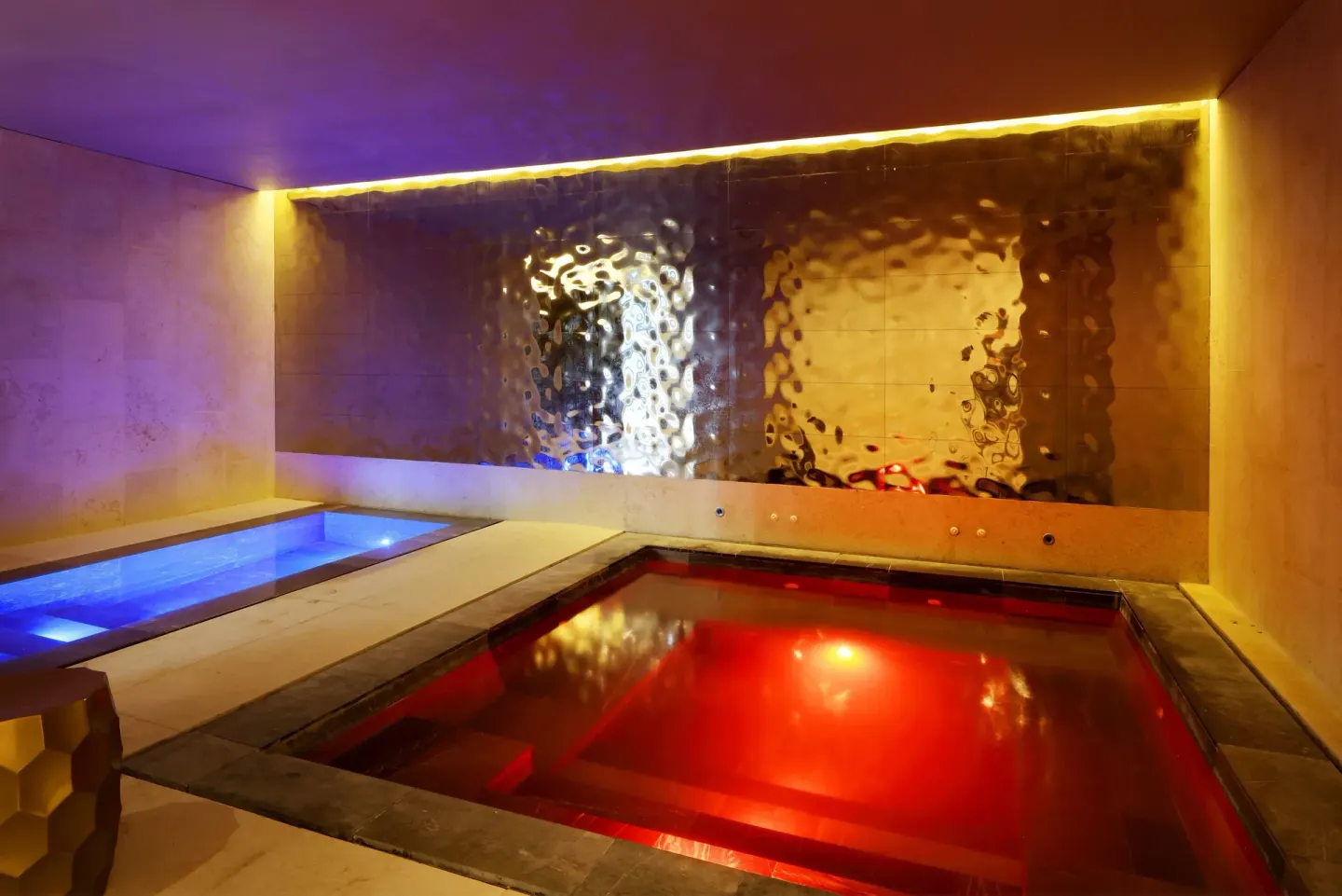 Spa plunge pools with red and blue lighting and water wall at TRS Coral Hotel.