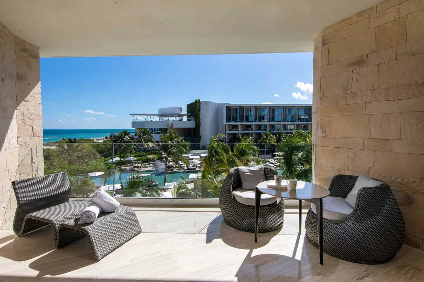 Junior Suite Beachside terrace with loungers and ocean view at TRS Coral Hotel.