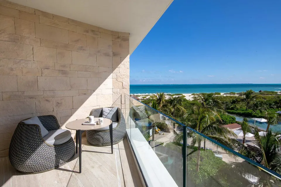 Junior Suite Ocean View balcony with seating and sea view at TRS Coral Hotel.