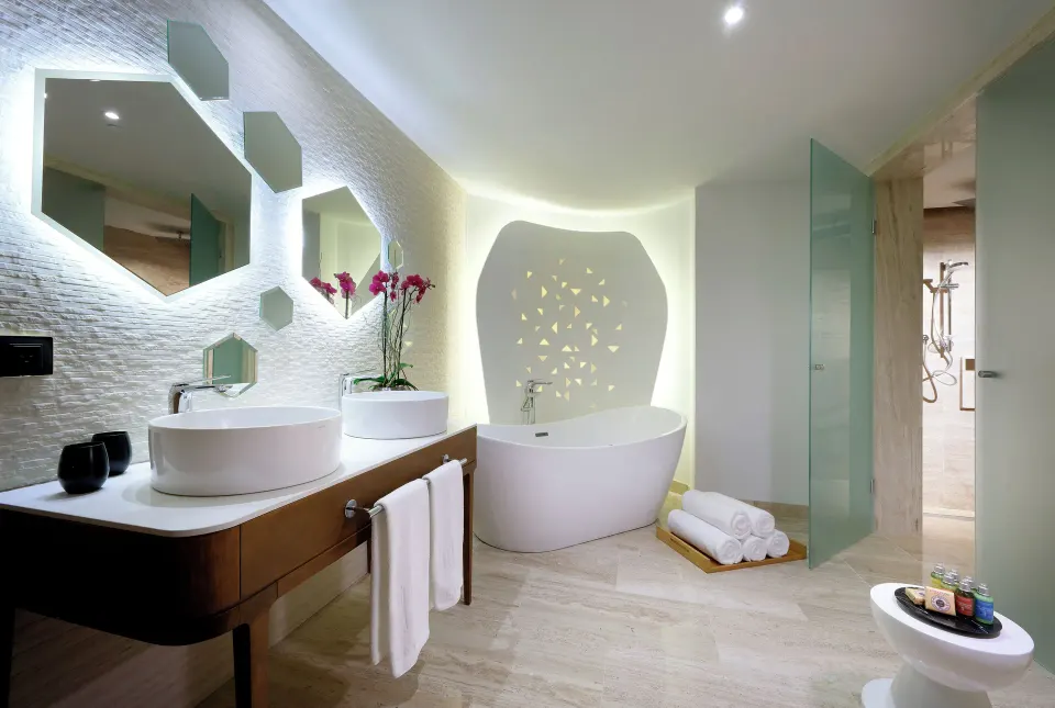 Loft Suite bathroom with double sinks and freestanding tub at TRS Coral Hotel.